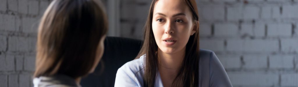 Two ladies discussing a proposal.