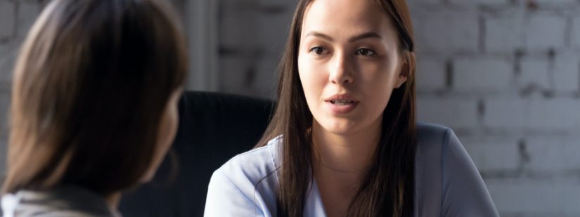 Two ladies discussing a proposal.